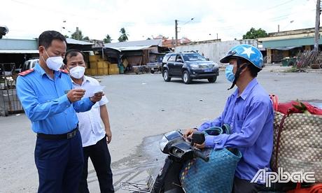 Kiểm tra giấy test thương lái ra vào chợ Vĩnh Kim.